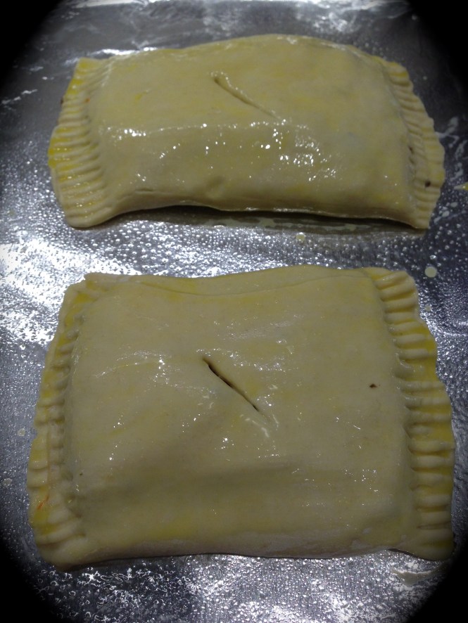 Brush the pastry with an egg wash and cut a slit in the center to release steam