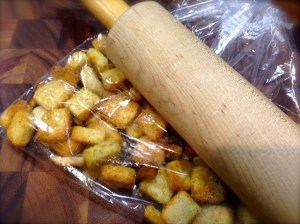 Place the croutons in a bag and crush with a rolling pin...