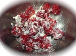 Lightly flour the raspberries to prevent them from all falling to the bottom