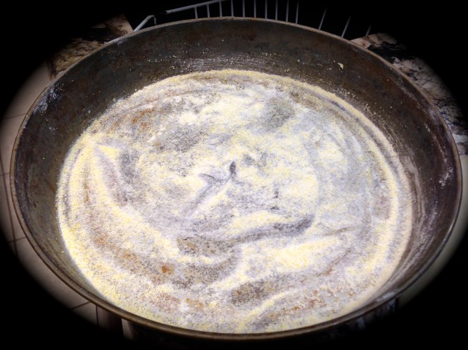 Dust the bottom of the pan with cornmeal...