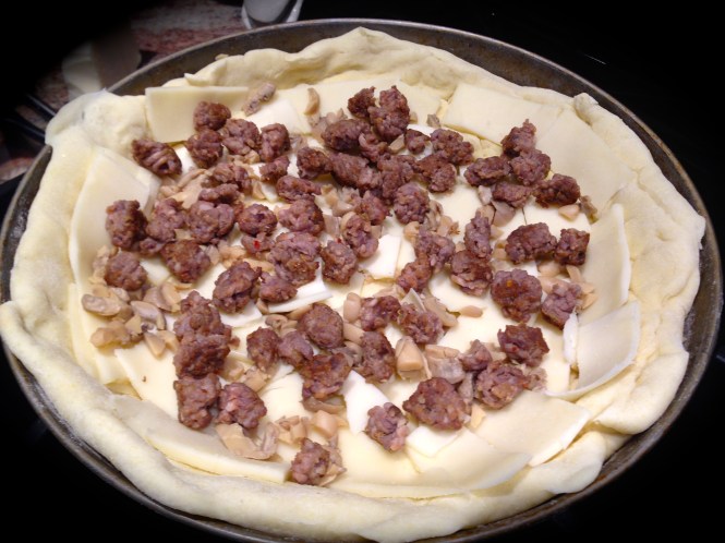 Add your preferred ingredients (we used sausage and mushrooms)