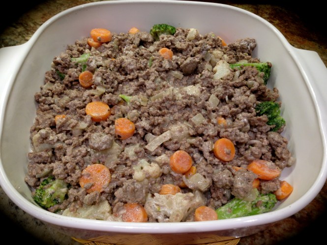 Add the sour cream to the meat mixture and spread in the bottom of the dish...