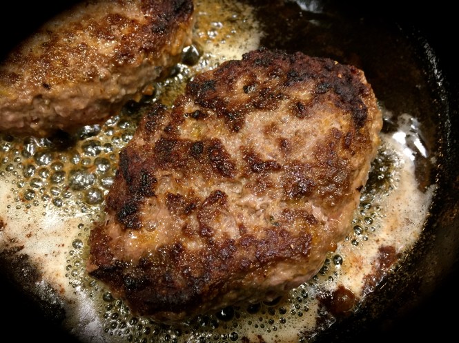 Patties cooked in a cast iron skillet