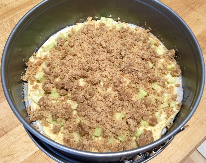 The first layer completed with batter, apples and crumble