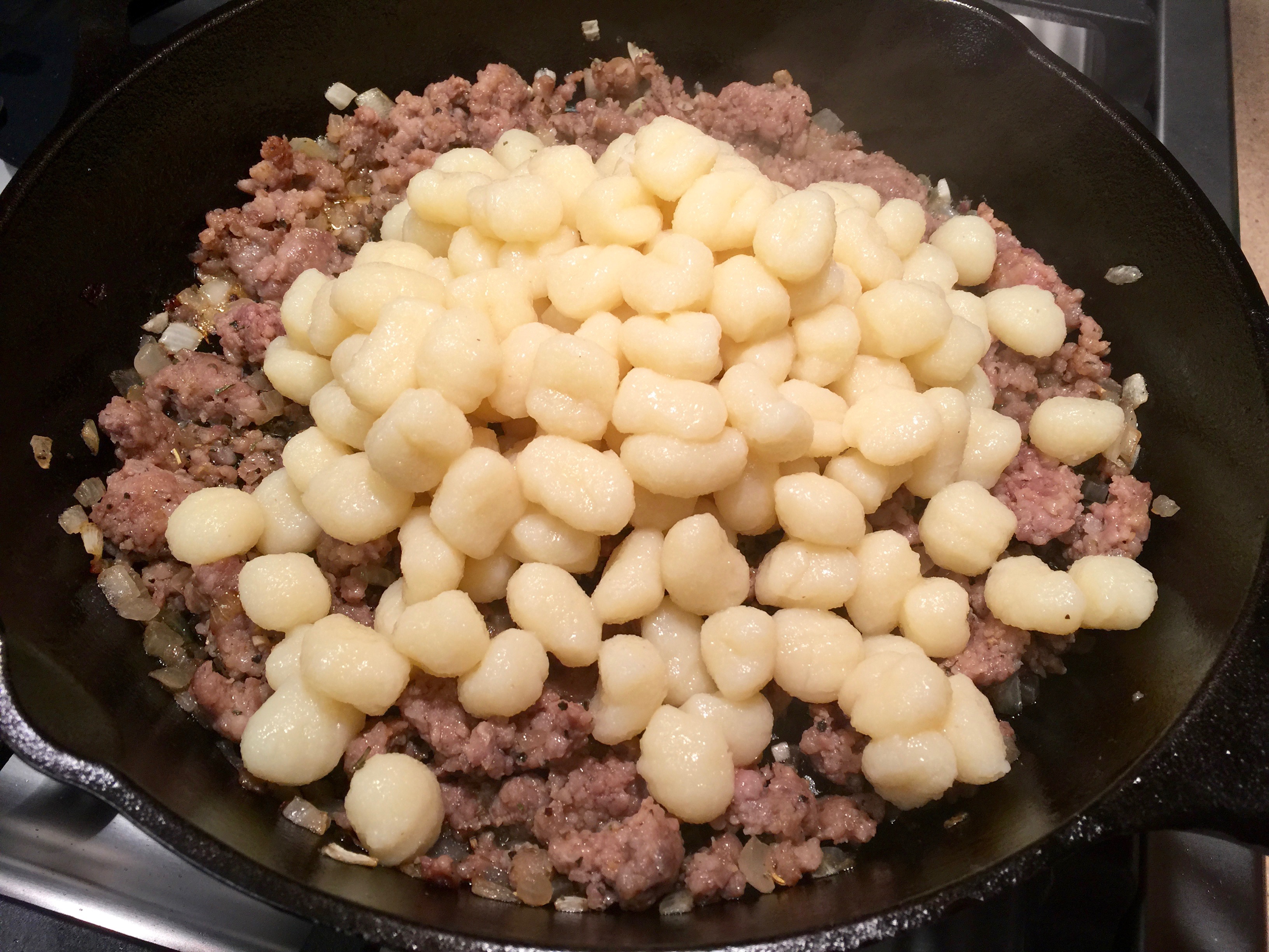 Add the cooked gnocchi to the sausage mixture