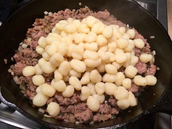Add the cooked gnocchi to the sausage mixture